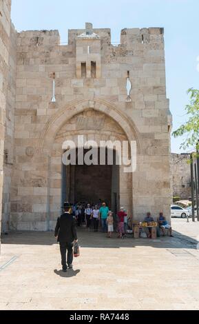 Man with traditional Jewish clothes in front of the city wall, Jaffa Gate, Old Town, Jerusalem, Israel Stock Photo