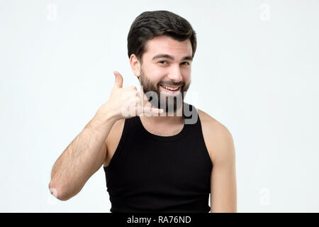 Young handsome man making call me sign Stock Photo