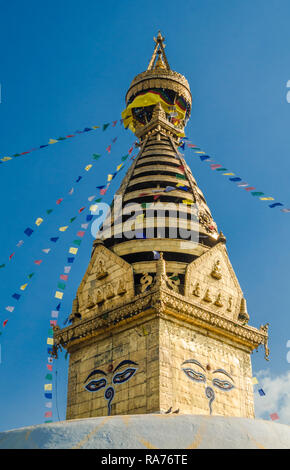 The gold spire and Buddhist prayer flags of Swayambhunath Stupa, Kathmandu, Nepal Stock Photo