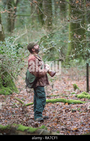 man shooting in woodland Stock Photo