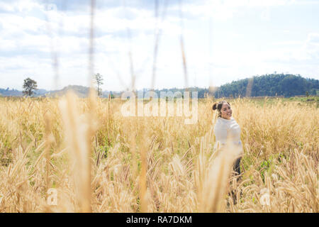 The girl is traveling in the grass field desho grass. Stock Photo