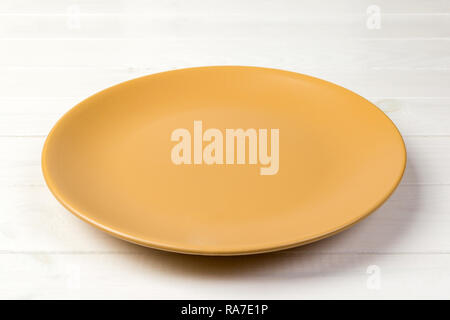 Download Perspective View Empty Yellow Matte Plate On Orange Wooden Background Stock Photo Alamy Yellowimages Mockups