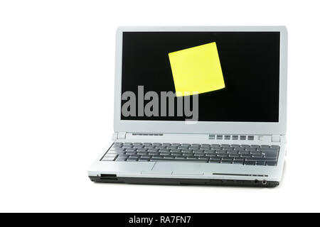 Empty yellow sticky paper note on laptop with copy space over white background Stock Photo