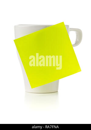 Yellow empty sticky note on white coffee or tea cup over white background with copy space Stock Photo