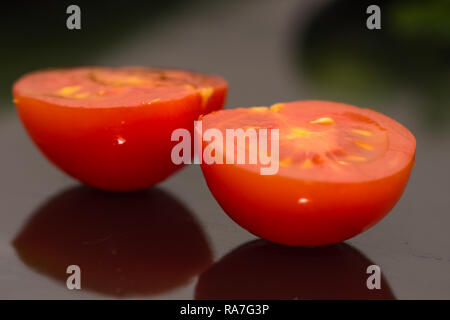 Isolated closeup shot of cut small tomatoes Stock Photo