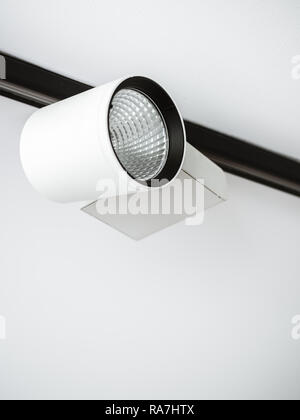 White track light on ceiling in white room with copy space vertical style. Stock Photo