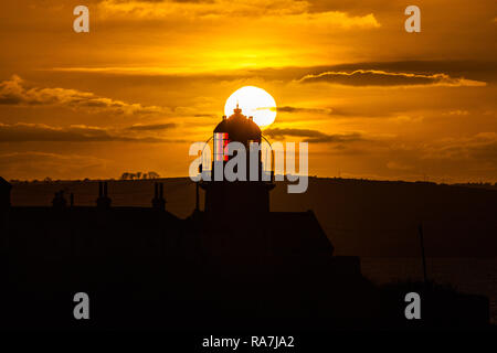 Roches Point, Cork, Ireland. 07th January, 2018 The Sun goes down on a January evening silhouetting the lighthouse at Roches Point Co. Cork Stock Photo