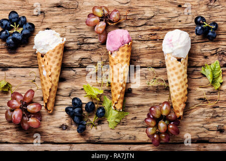 Ice cream sundae, waffle cone.Grape ice cream.Ice cream cones on wooden table Stock Photo