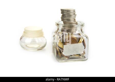 Full jar of coins  with blank label. Savings concept Stock Photo