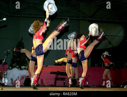 The Dallas Cowboys Cheerleaders perform during the Secretary of Defense Holiday Tour 2000, in Hangar 3 at Ramstein Air Base, Germany, on December 17th 2000. Stock Photo