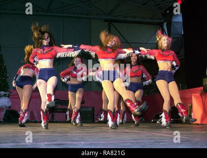 The Dallas Cowboys Cheerleaders perform during the Secretary of Defense Holiday Tour 2000, in Hangar 3 at Ramstein Air Base, Germany, on December 17th 2000. Stock Photo