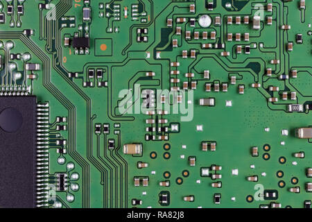 Microchips and microcircuits are installed on a modern electronic circuit board.  Mass production. Super macro studio concept Stock Photo