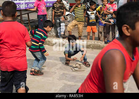 Mumbai, Maharashtra / India - December 10 2017: Children playing Lagori, a traditional childrenâ€™s game, where two teams try to hit a pile of stones. Stock Photo