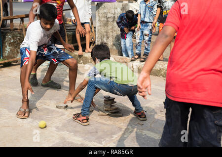 Mumbai, Maharashtra / India - December 10 2017: Children playing Lagori, a traditional childrenâ€™s game, where two teams try to hit a pile of stones. Stock Photo