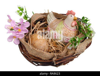 Easter nest with ceramic chicken and wooden egg. Isolated on white studio macro Stock Photo