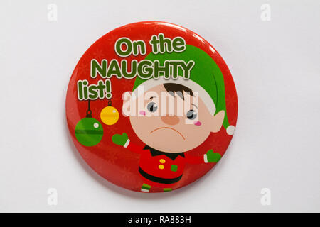 On the naughty list elf red round badge, pin badge, isolated on white background - for wearing at Christmas Stock Photo