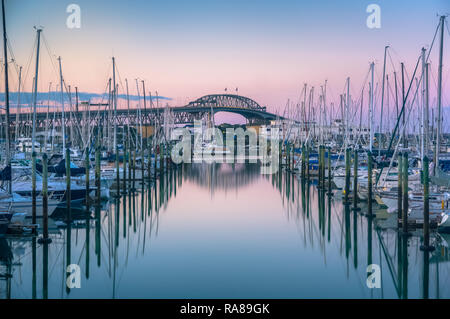 Auckland Marina Sunset Long Exposure in front of the Auckland Harbour Bridge Stock Photo