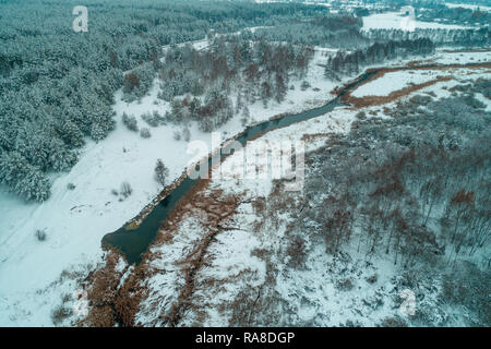 View from above of countryside and narrow winding river in snowy winter Stock Photo