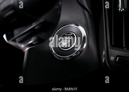 Car dashboard with focus on engine start stop button. Modern car interior details. Car detailing Stock Photo