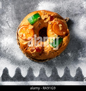 high angle view of a roscon de reyes, spanish three kings cake eaten on epiphany day, on a gray rustic table Stock Photo