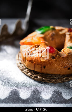 closeup of a roscon de reyes, spanish three kings cake eaten on epiphany day, on a gray rustic table Stock Photo