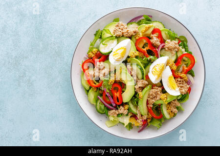 Tuna salad with boiled egg and fresh vegetables. Healthy diet food. Greek cuisine. Top view Stock Photo