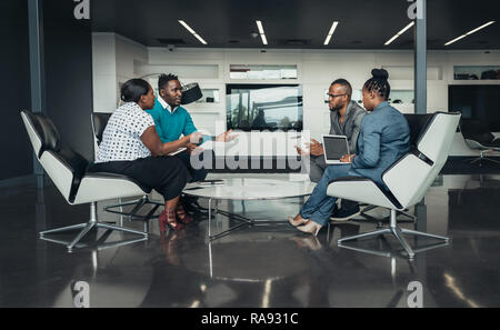 Team of african bussines people sitting in a modern office and talking during an work meeting Stock Photo