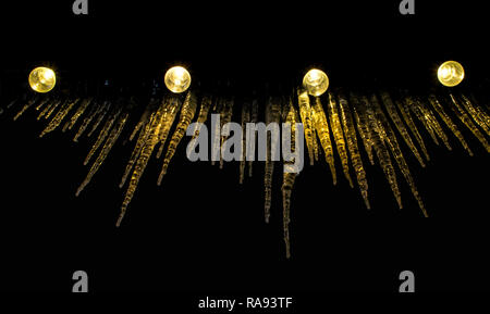 Light bulbs and icicles in background Stock Photo