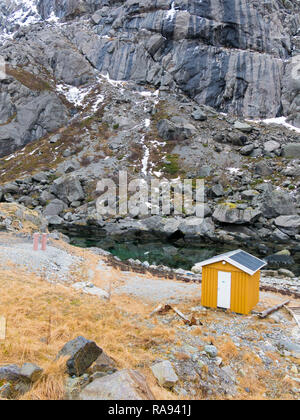 Yellow wooden fisherman shed in Nusfjord, Flakstadoya, Lofoten Islands, Nordland, Norway Stock Photo