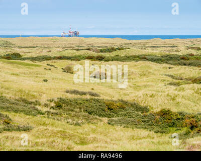 Panorama of dunes of nature reserve Het Oerd and offshore platform in North Sea off coast of West Frisian island Ameland, Friesland, Netherlands Stock Photo