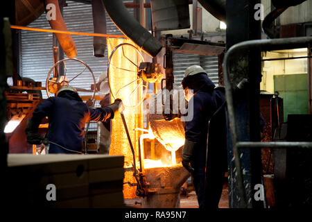 Molten steel pouring from crucible during steel manufacture Stock Photo