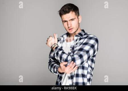 Handsome man suffering from elbow pain caused by rheumatism or trauma bone on white background Stock Photo