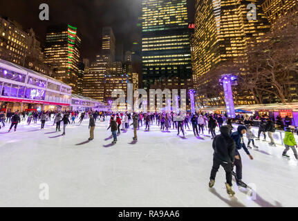 Ice Skaters at Ice skating rink at the Bryant Park Holiday Market in Bryant Park, New York City. Stock Photo