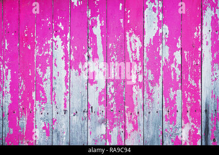 Old cracked wooden board painted with pink paint. Abstract background. Stock Photo