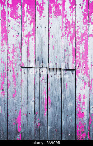Old cracked wooden board painted with pink paint. Abstract background. Stock Photo