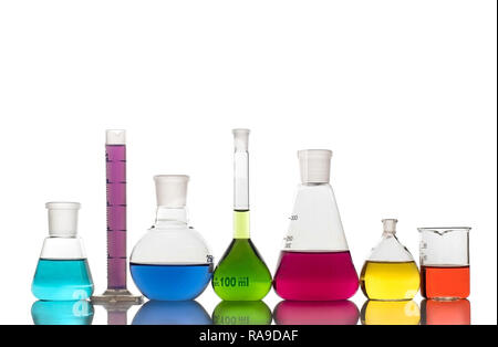 Laboratory glassware with colorful liquids on white background Stock Photo