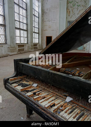 Abandoned building interior, empty hall, broken grand piano Stock Photo