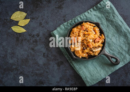 Bigos-traditional Polish dish of finely chopped sauerkraut and fresh cabbage with meat, mushrooms, and sausage. The dish is also traditional for Belar Stock Photo