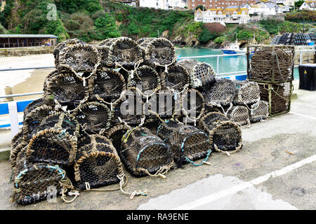 Creel Shape Lobster Crab pots stacked on the quay in Newquay Harbour Harbor in Newquay in Cornwall. Stock Photo