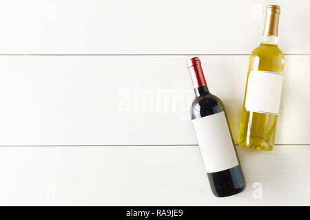 Red and white wine bottle on white wooden table flat lay from above with copy space Stock Photo