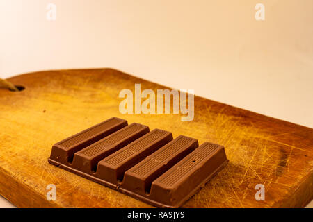 Chocolate bars on a rustic wooden board. Sweet food Stock Photo