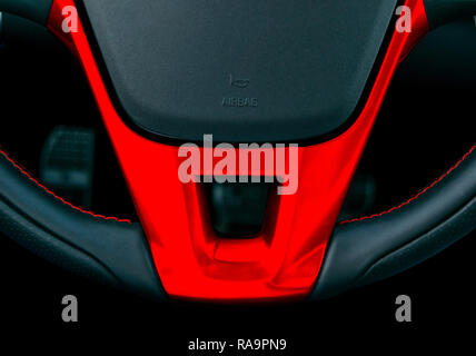 Close up view of steering wheel with red stich, Black leather car interior design, Car interior details Stock Photo