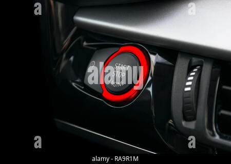 Car dashboard with focus on Red engine start stop button, car interior details Stock Photo