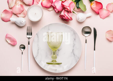 Romantic table setting in pink colors. Tableware and decorations for serving a festive table. Stock Photo