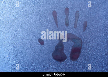 Hand print on icy window. Close up of hand print Stock Photo