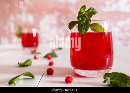 On the table is the juice of viburnum berries with mint and ice Stock Photo