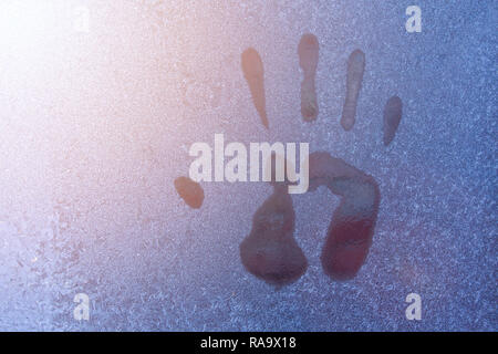 Hand print on icy window. Close up of hand print Stock Photo