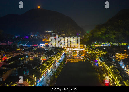 Beautiful bridge and old houses in Fenghuang Ancient Town at night Stock Photo