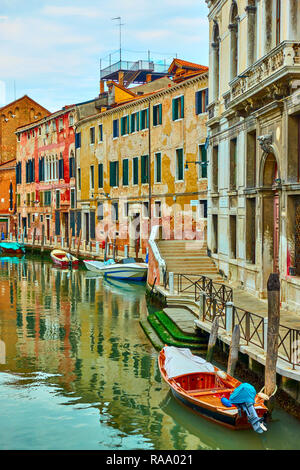 Picturesque canal with moored boats in Venice, Italy Stock Photo