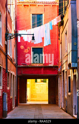 Colorful old venetian courtyard with drying linen outside, Venice, Italy Stock Photo